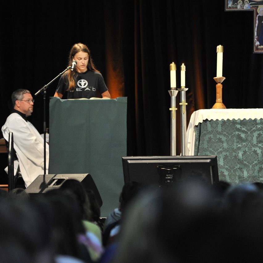 girl LEAD doing the mass reading at main campus 1, 2015