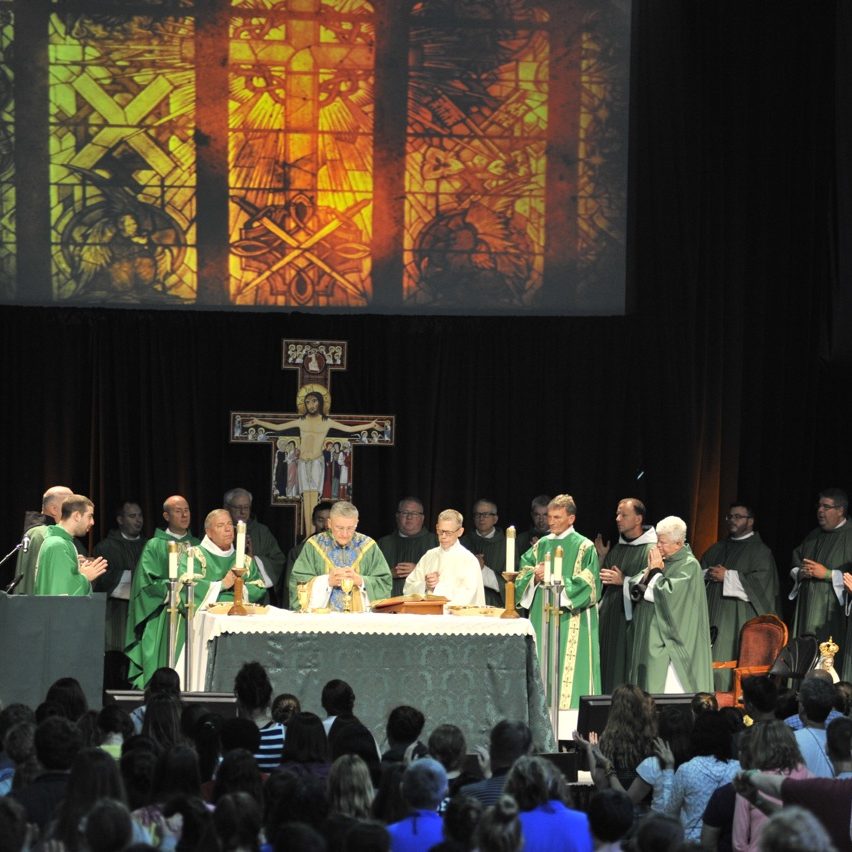priests gathered at the alter during mass at main campus 1, 2015