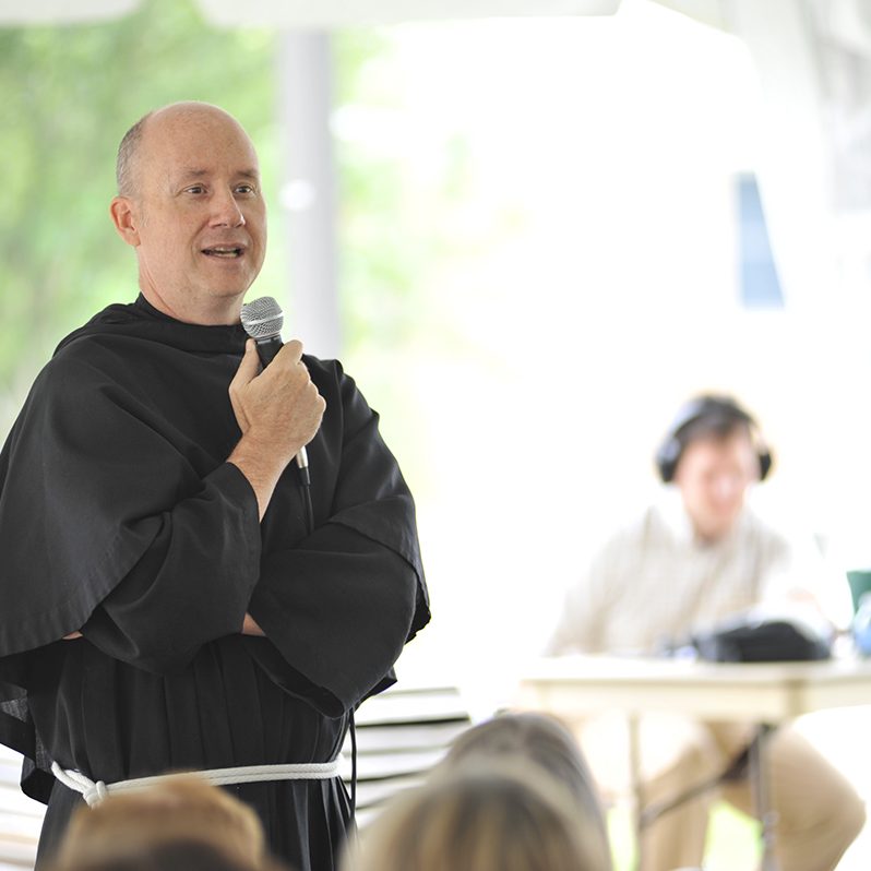 Father dave giving talk in the tent during power and purpose conference, 2015