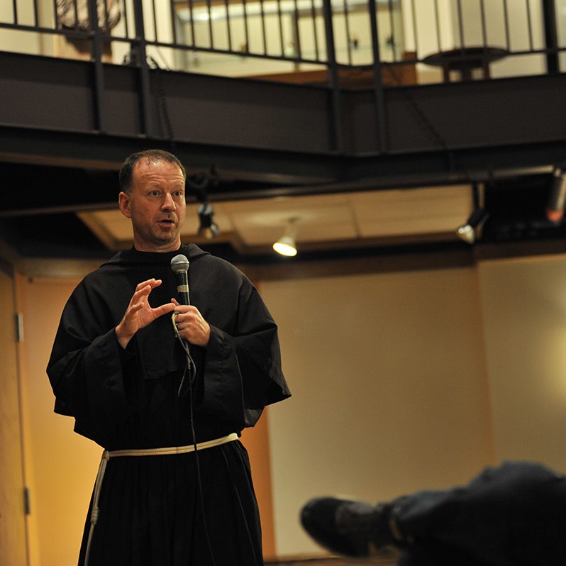 Father Dave giving a talk at power and purpose conference, 2015