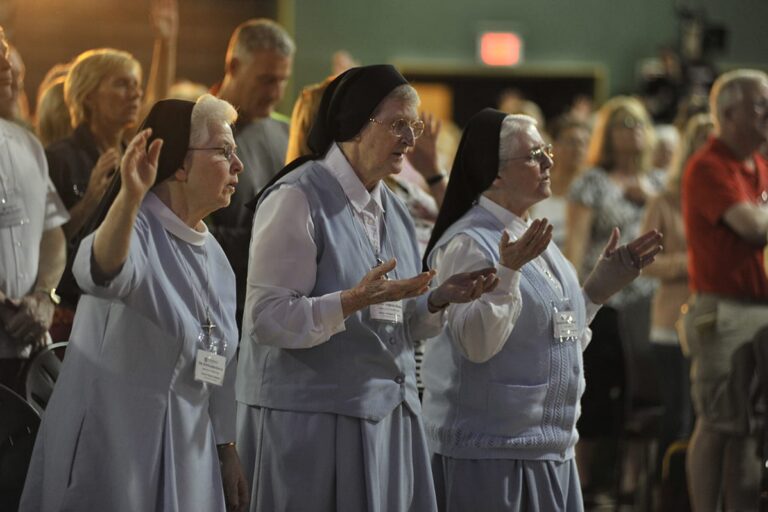 nuns in prayer at power and purpose conference, 2015