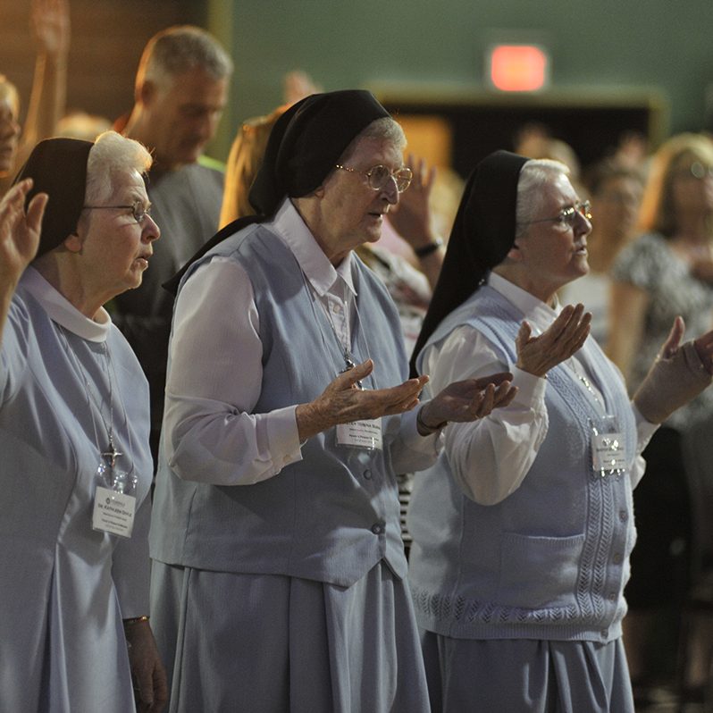 nuns in prayer at power and purpose conference, 2015
