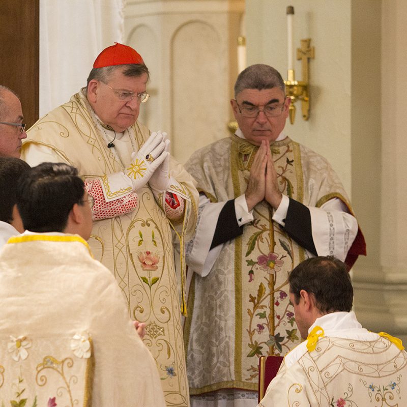 Cardinal blessing priest for gospel reading in St. Peters Church