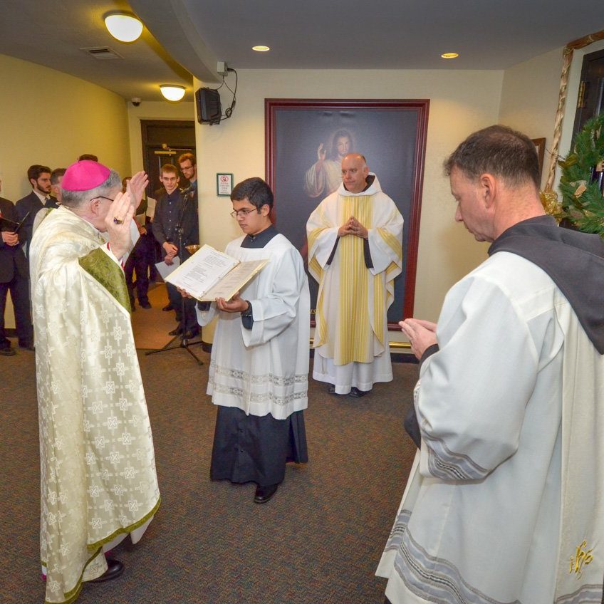 bishop montforton blessing the holy door, in Christ the king chapel