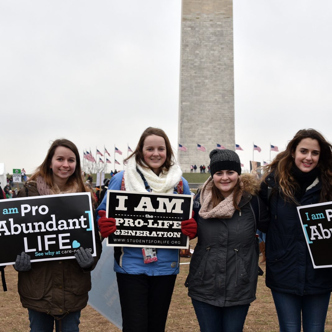 6 students in front of the Washington with pro-life signs