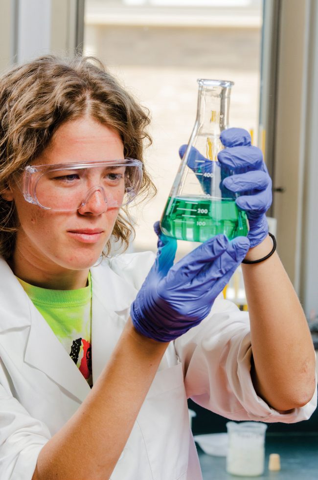 student working with chemicals