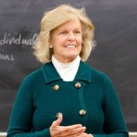 Dr. Anne Hendershott standing in front of a blackboard.