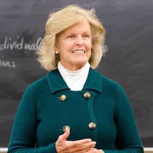 czeptSqA Dr. Anne Hendershott standing in front of a blackboard.