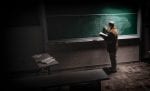 Professor writing on a chalkboard