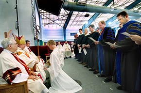 teachers lined up in front of bishop for oath of fidelity