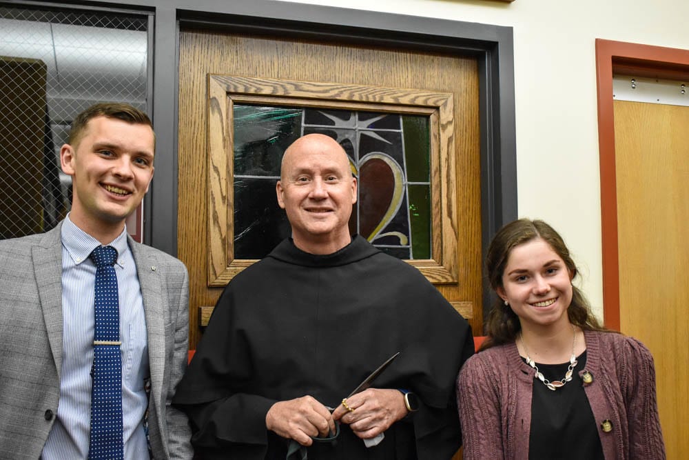 Clement Harrold, senior; Father Dave Pivonka, TOR, president; and Justine Smykowski, senior, revealed the Totus Tuus Maria Group Study Room in a ribbon-cutting ceremony.