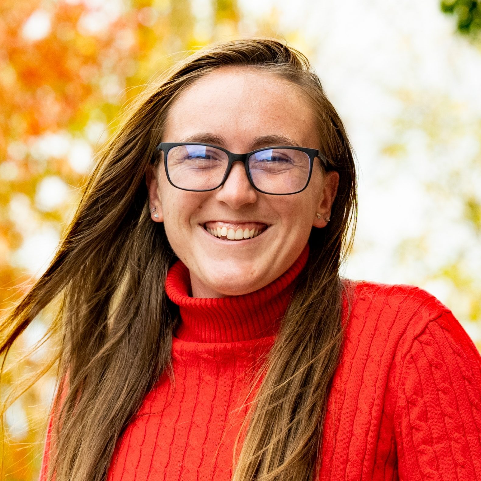 Student with red sweater smiling