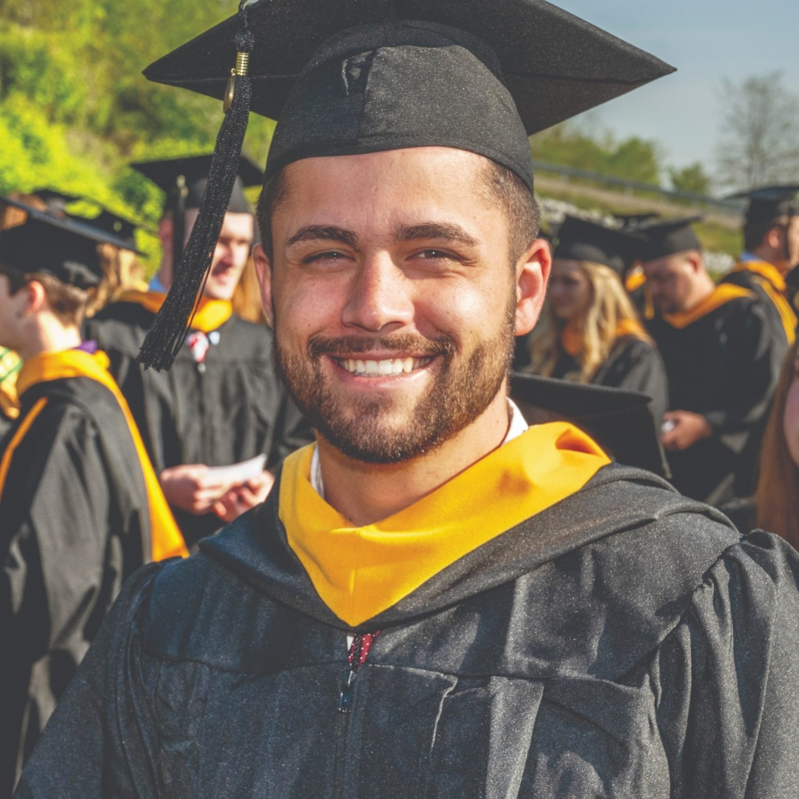 Student smiling during graduation ceremony