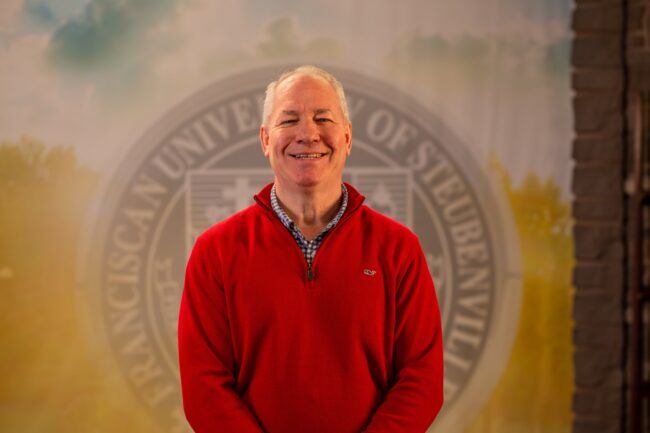 To Web – Dr. Donald Kissinger FEB2025 –3 Dr. Donald Kissinger standing in front of a university seal.