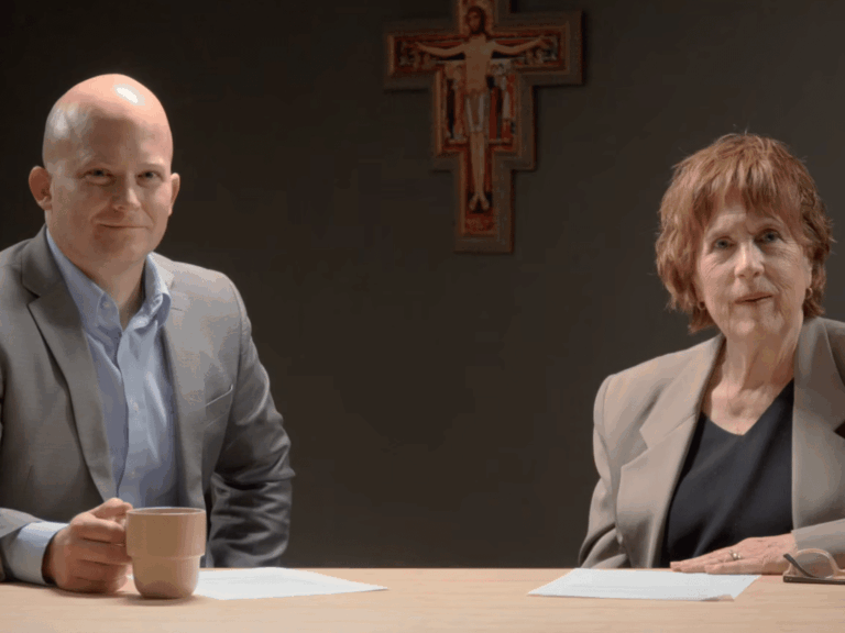 Dr. John Bishop and Dr. Deborah Savage seated at a table for an interview.