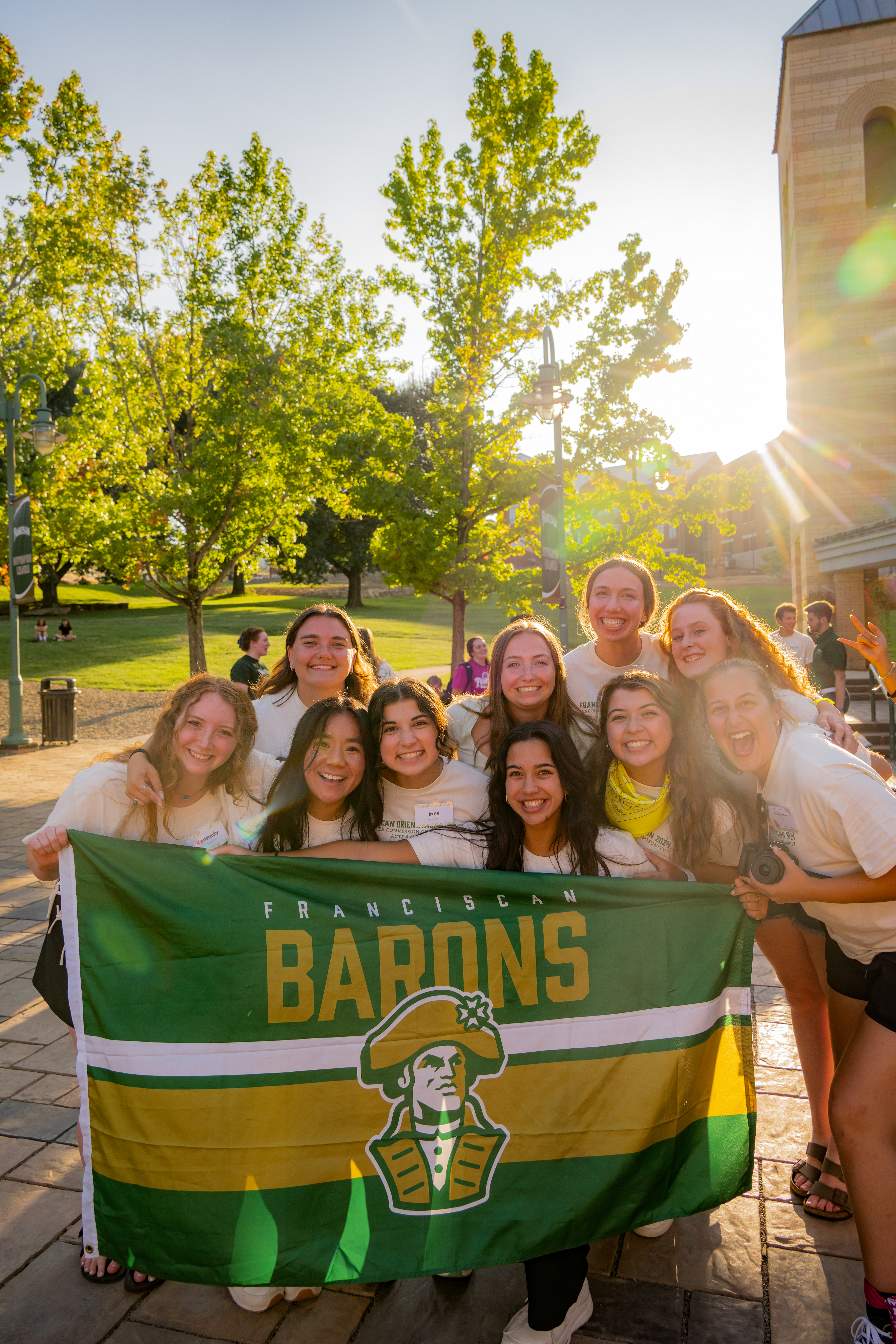 Franciscan University students holding a Barons flag