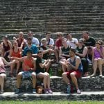 Students sitting on ancient stone steps