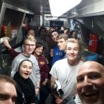 Students standing in a long kitchen