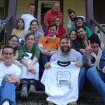 Group of volunteers on the steps to a house