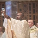 Priest Lifting the chalice