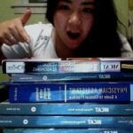 Student pointing at textbooks