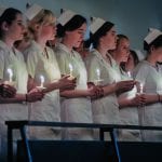 Nursing majors holding candles during nursing dedication