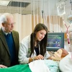 Professor Antinone assisting a nursing student with a nursing dummy