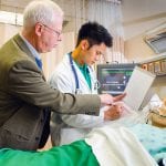 Teacher and student over nursing dummy