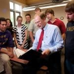 Professor reading with students