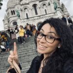 Dr. Fernanda Psihas pointing up to a church.